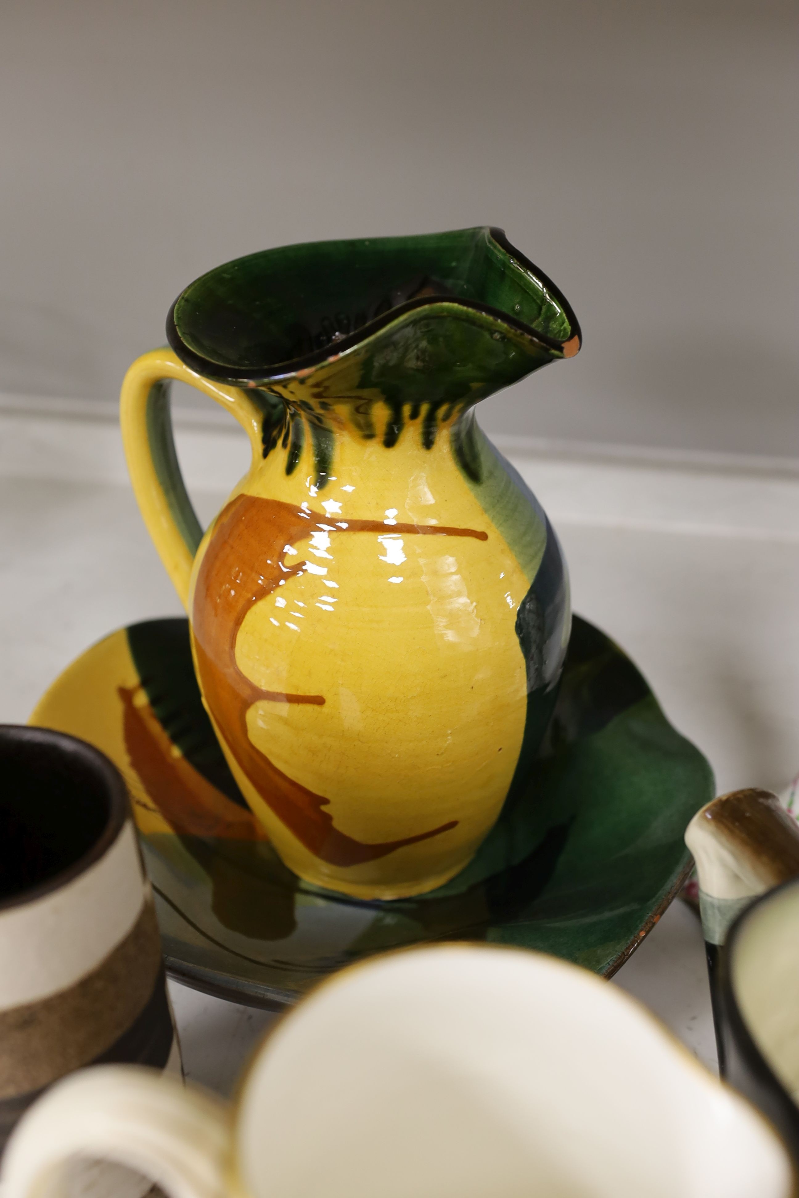 A pair of Dresden candlesticks, various art pottery jugs and a dish and other ceramics